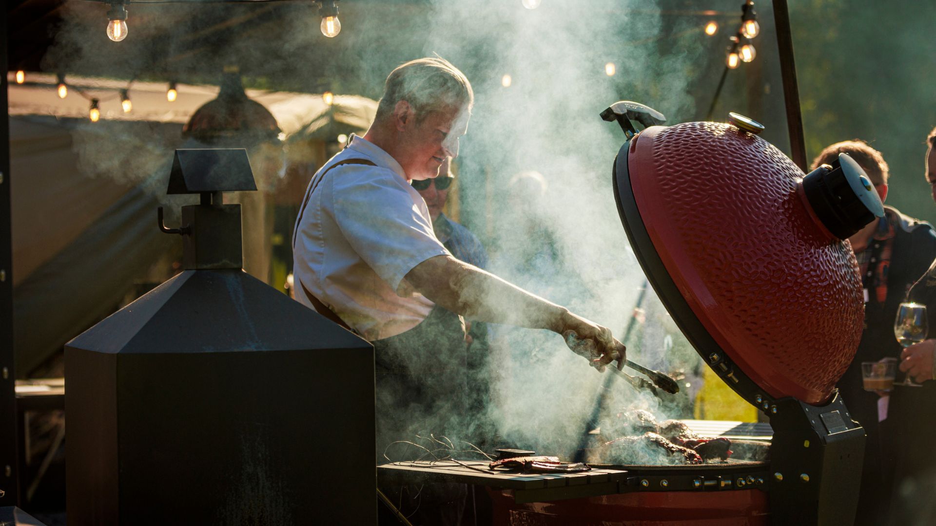 Social cooking or catering in an outdoor kitchen equipped with various grills