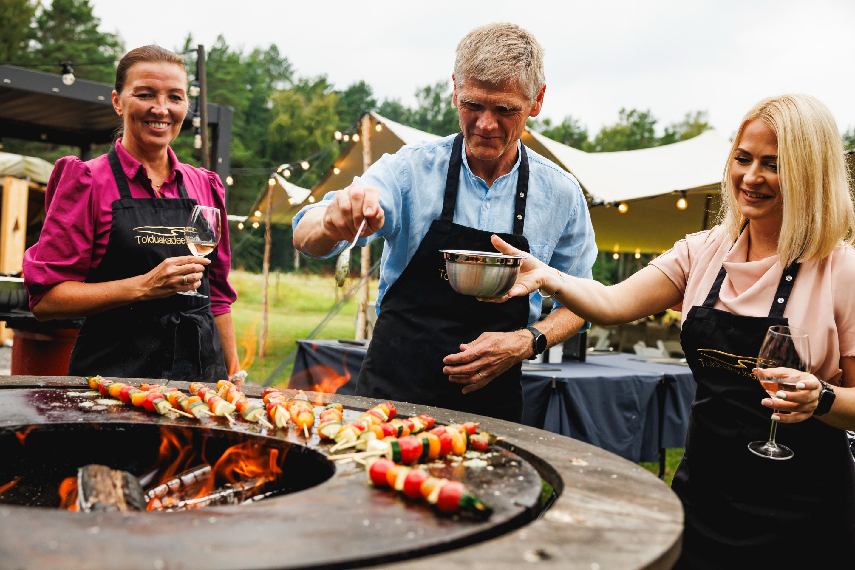 Social cooking or catering in an outdoor kitchen equipped with various grills